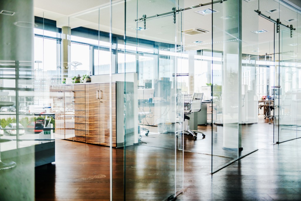 Office rooms divided by glass