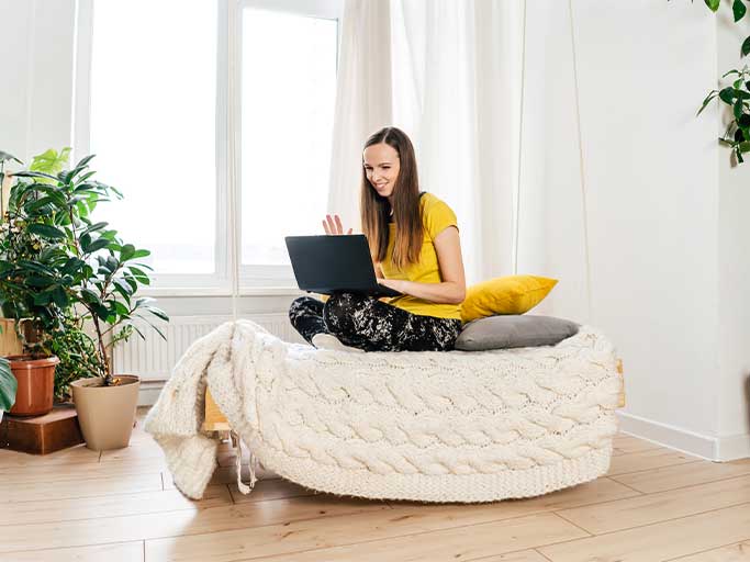 girl with a laptop sitting on a couch